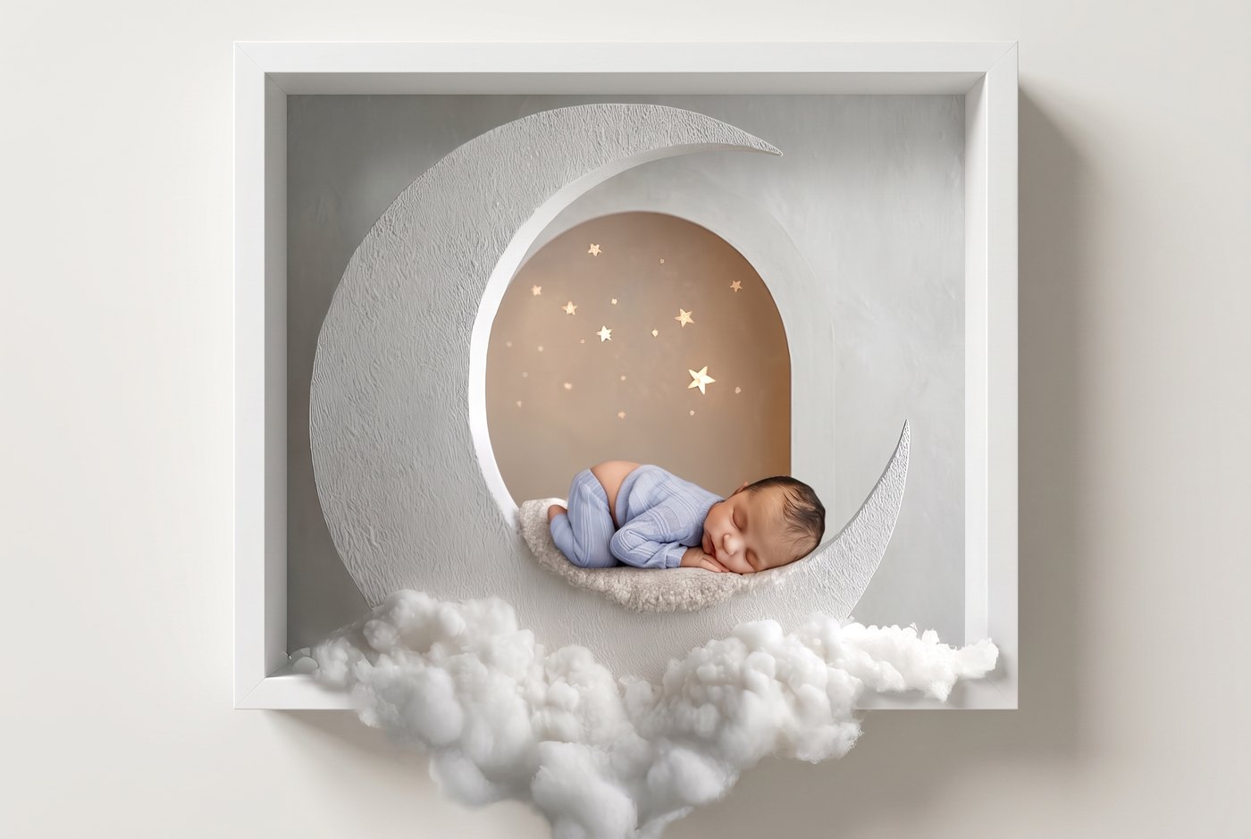 Newborn on a crescent moon breaking out of a white frame