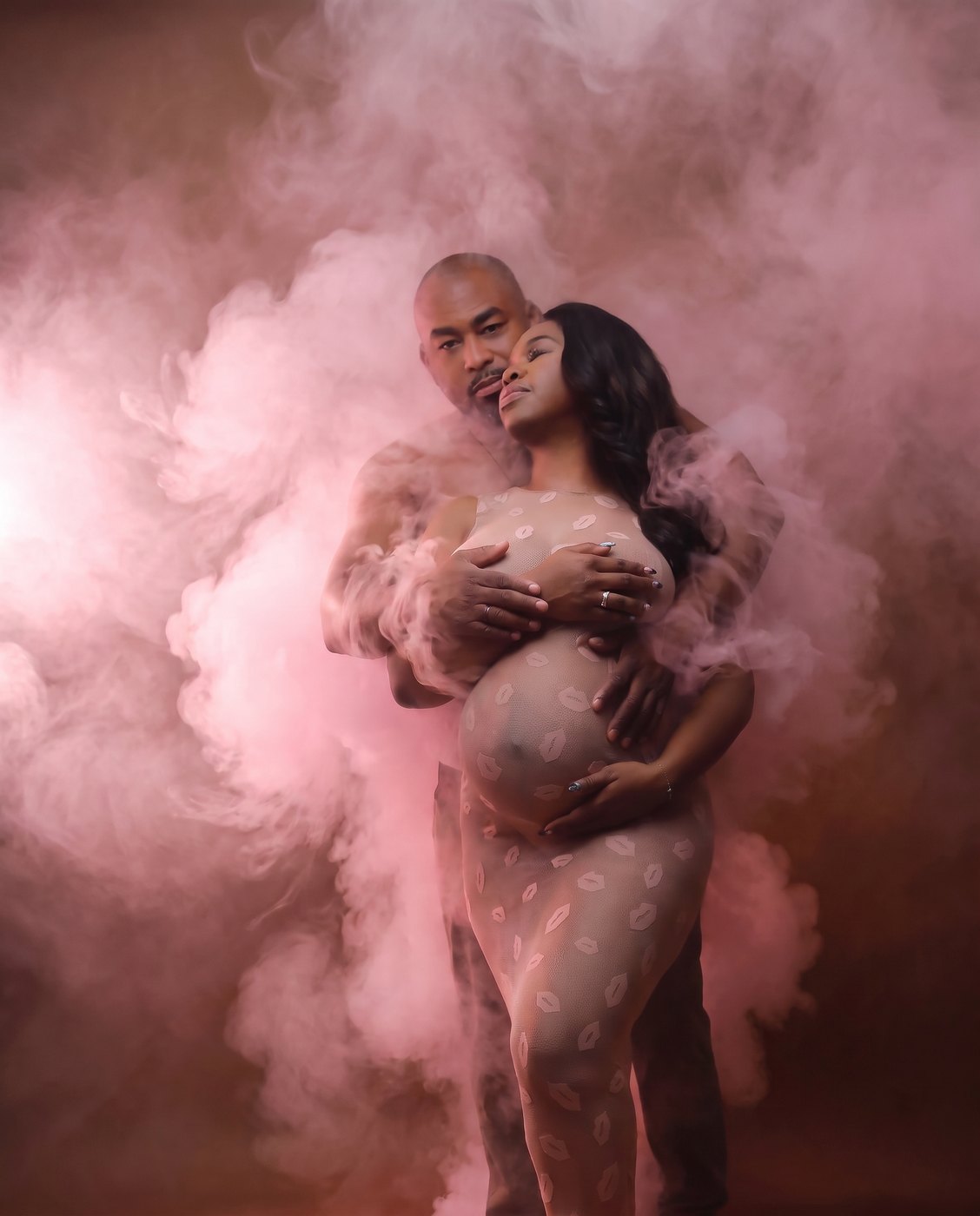 Maternity portrait with pink smoke