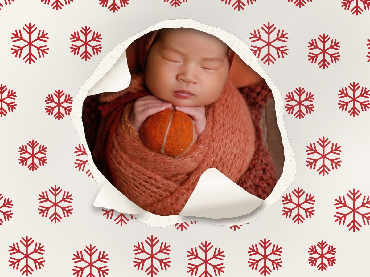 Gift Wrap Studio: a newborn peeking through torn snowflake wrapping paper