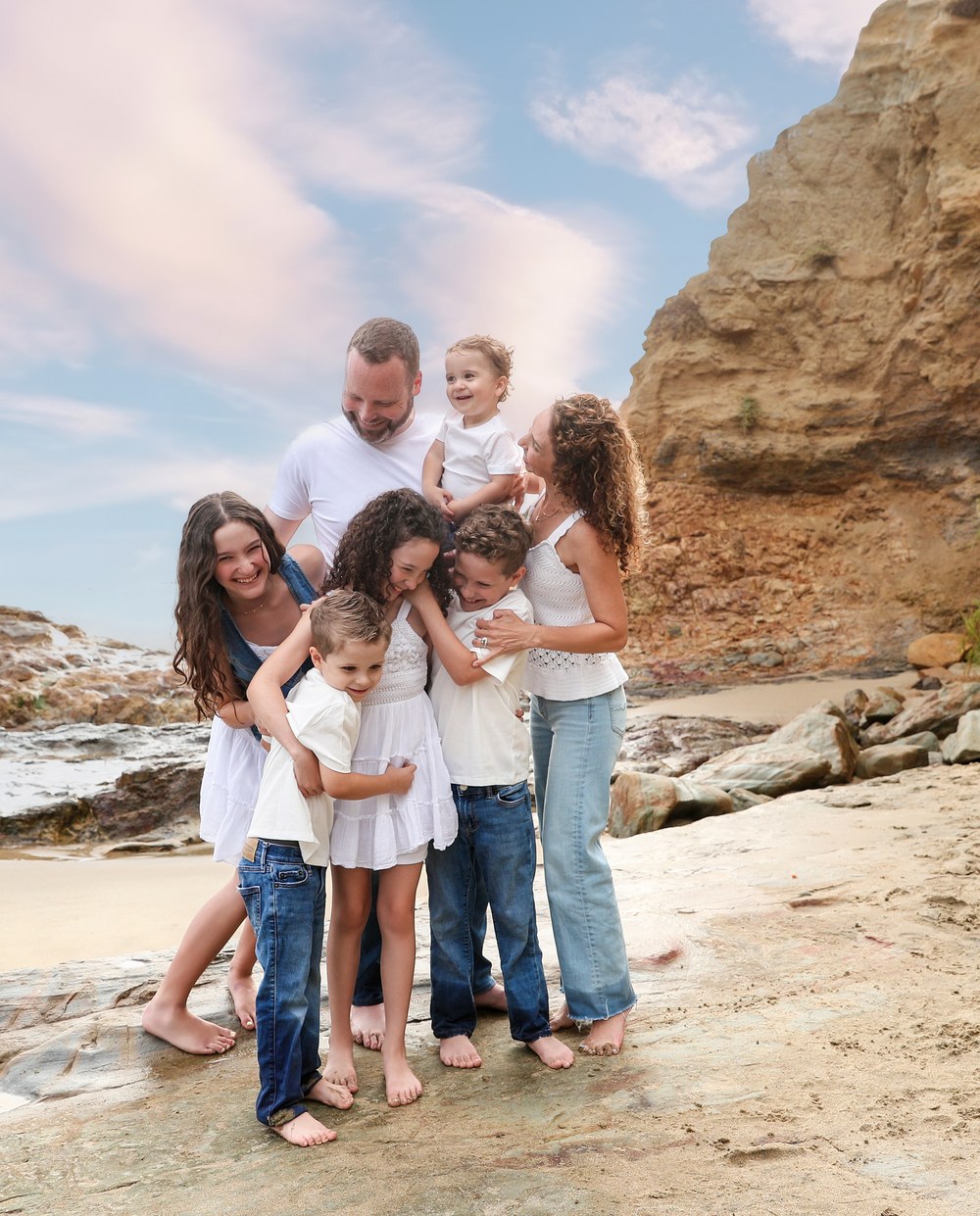 Family of five walking on the beach in cream and warm brown, the session a style guide was written for